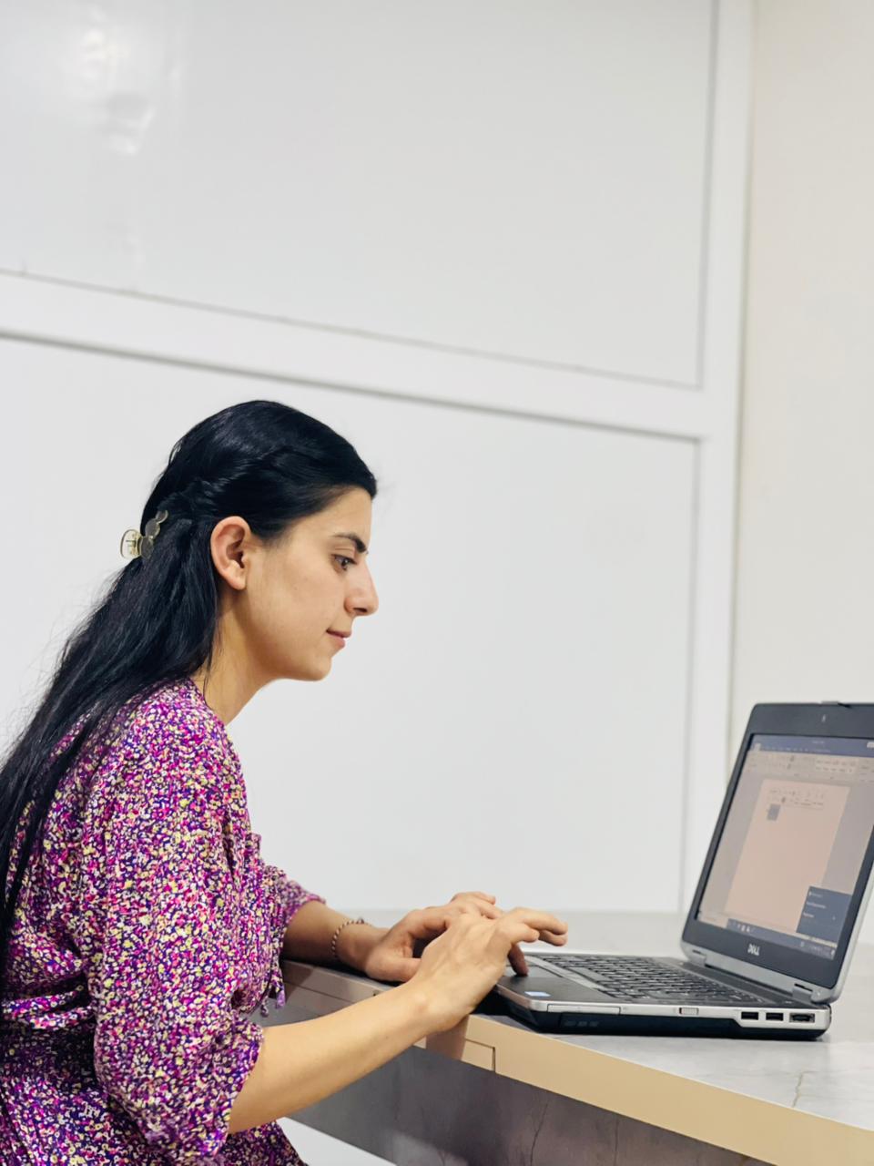 Yazidi student in Sinjar using a donated laptop for English class